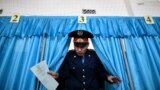 Kzakhstan -- A Kazakh policeman votes during parliamentary elections in the Kazakh city of Baikonur, also known as Russian-leased Baikonur cosmodrom, March 20, 2016