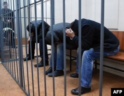 Three unidentified Nemtsov murder suspects in the defendants’ cage in Moscow’s Basmanny District Court on March 8, 2015