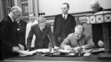 Soviet Union -- USSR. Moscow. Minister of foreign affaires of the USSR Vyacheslav Molotov signs the Non-aggression Pact between Germany and the USSR (the Molotov-Ribbentrop Pact). Josef Stalin is pictured at the signing ceremony, Moscow, 28 September 1939