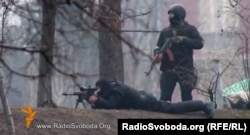 Police use a Kalashnikov assault rifle and sniper rifle against Euromaidan protesters in Kyiv on February 20, 2014.
