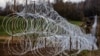 POLAND – Polish military personnel build a barbed wire fence along the border with Russia's Kaliningrad region on November 3, 2022. Kaliningrad Oblast is a Russian enclave bordering Lithuania and Poland