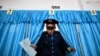 Kzakhstan -- A Kazakh policeman votes during parliamentary elections in the Kazakh city of Baikonur, also known as Russian-leased Baikonur cosmodrom, March 20, 2016