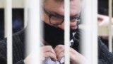 BELARUS -- Viktar Babaryka, the former head of Russia-owned Belgazprombank, gestures a heart symbol sitting in a cage in a court room in Minsk, February 17, 2021
