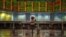 Malaisia -- A man sits before electronic boards showing stock movements at the Malaysia Stock Exchange in Kuala Lumpur,  07Jan2015