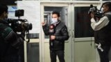 A news television team reports from outside an insloation ward for COVID-19 coronavirus