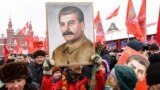 RUSSIA -- Russian Communist party supporters hold portraits of Soviet leader Josef Stalin as they gather to mark the Stalin's 139th birthday on the Red Square, in Moscow, December 21, 2018