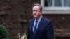Former British Prime Minister David Cameron walks outside 10 Downing Street in London