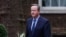 Former British Prime Minister David Cameron walks outside 10 Downing Street in London