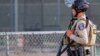 A police officer stands watch at the scene of a mass shooting during the Gilroy Garlic Festival in Gilroy, California, U.S. July 28, 2019. REUTERS/Chris Smead. NO ARCHIVES. NO RESALES.