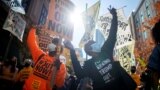 Philadelphia, Pennsylvania, U.S. - Activists dance in celebration after Democratic presidential nominee Joe Biden overtook President Donald Trump in the Pennsylvania general election vote count across the street from where ballots are being counted, three