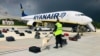 Belarusian security with a sniffer dog check the luggage of passengers in front of Ryanair's flight FR4978, which carried opposition figure Raman Pratasevich to Minsk on May 23, 2021.