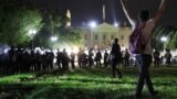 A protester holds his hands up as police officers enter Lafayette Park during a demonstration against the death in Minneapolis police custody of African-American man George Floyd, as the officers keep demonstrators away from the White House during a prote