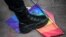 Turkey -- A Turkish anti-riot police officer steps on a rainbow flag during a rally staged by the LGBT community on Istiklal avenue in Istanbul, June 19, 2016