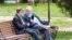 RUSSIA -- Pyatigorsk, May 27, 2018: Two elderly people sitting on a bench discussing the news, reading them in their smartphones
