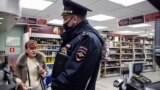 RUSSIA -- A Russian police officer wearing a protective mask patrols inside a supermarket in Moscow, May 13, 2020