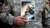 IRAN -- A demonstrator holds the picture of Qassem Soleimani during a protest against the assassination of the Iranian Major-General Qassem Soleimani, head of the elite Quds Force, and Iraqi militia commander Abu Mahdi al-Muhandis who were killed in an ai