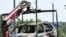 The wreckage of a car is loaded onto the platform of a truck after a blast caused by an explosive device killed its driver in Balashikha, outside Moscow, on June 9, 2026. (Photo by Igor IVANKO / AFP)