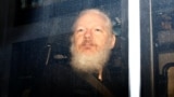 U.K. -- WikiLeaks founder Julian Assange is seen in a police van, after he was arrested by British police, in London, April 11, 2019