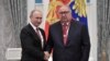 Russia -- Russian President Vladimir Putin (L) shakes hands with Russian businessman and founder of USM Holdings Alisher Usmanov during an awarding ceremony at the Kremlin in Moscow, November 27, 2018