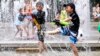 JAPAN - Children play in the water jets at a park near Nerima in Tokyo, Japan, 23 July 2018 as temperature rose up to 39.6 degrees Celsius