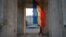 A woman walks under the Triumph Arch next to Moldovan flag on Stefan Cel Mare street in Chisinau city October 8, 2013. In Moldova