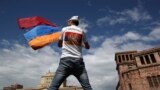 ARMENIA -- A man waves an Armenian flag at the Republic Square in Yerevan, Tuesday, May 8, 2018.