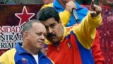 Venezuela -- Venezuelan President Nicolas Maduro (R) speaks with the president of the National Assembly, Diosdado Cabello after receiving the decree powers law, in Caracas, March 15, 2015
