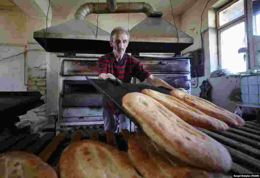 On October 9, 2020, the day talks began in Moscow on a ceasefire between Armenian and Azerbaijani forces, a man in the main Karabakhi town of Stepanakert (Khankendi) bakes bread. The breakaway region receives most of its foodstuffs from Armenia. Its agricultural sector was largely destroyed during Armenia and Karabakhi separatists&#39; 1992-1994 war with Azerbaijan.&nbsp;