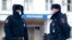  Police officers stand outside a police station