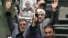 IRAN -- Iranian lawmakers holding pictures of slain Iran's Quds Force leader Qasem Soleimani as they chant 'death to America', during a parliament session in Tehran, January 7, 2020