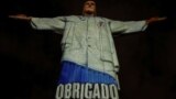Easter -- The statue of Christ the Redeemer is lit with an image of the attire of a healthcare personnel