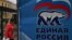 Russia -- A woman walks by an election poster for the United Russia party in central Moscow, September 14, 2016