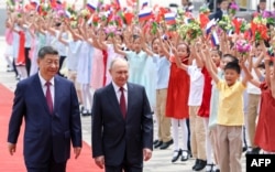 Си Цзиньпин и Владимир Путин во время официального визита главы России в Пекин 20 мая 2026 года