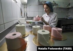 A pastry chef makes desserts in the shape of toilet paper rolls at the Cakes.by confectionery company in Minsk, Belarus to symbolize global toilet paper shortages during the COVID-19 crisis..