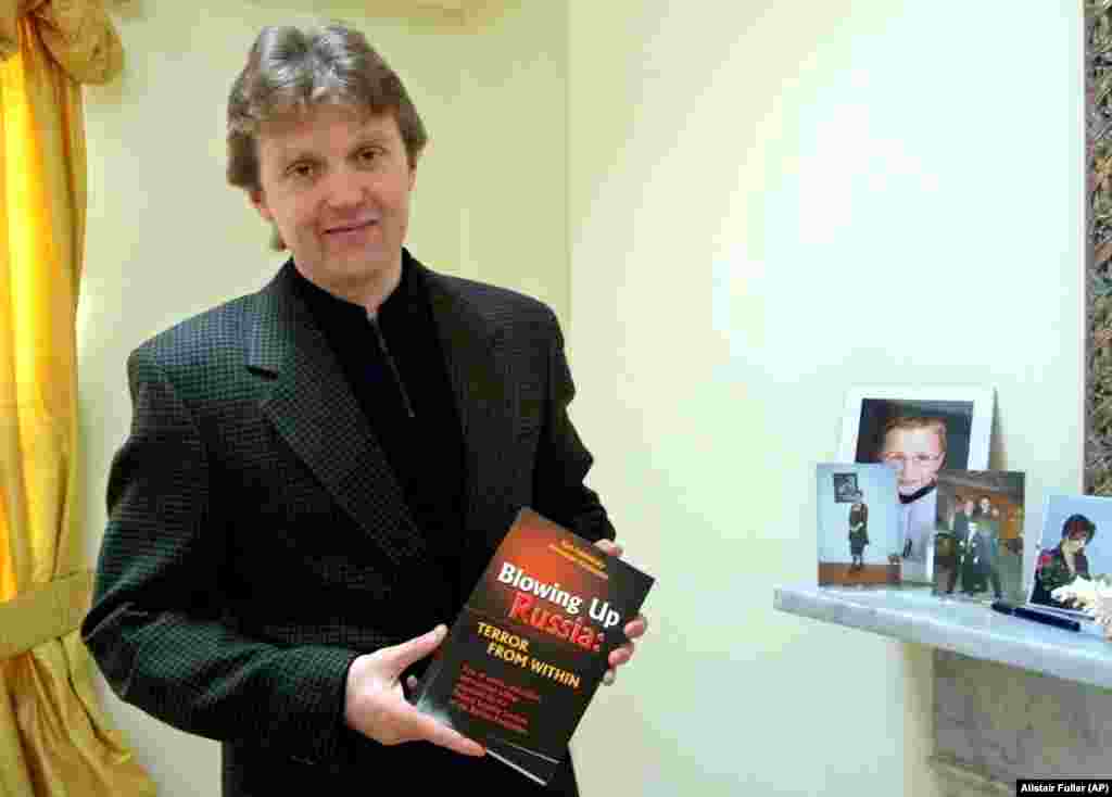 Litvinenko poses with his book, Blowing Up Russia: Terror From Within, at his home in London in May 2002. In the book, he accused the Russian secret services of staging the Russian apartment bombings in 1999 and other acts of terrorism in an effort to bring Vladimir Putin to power.&nbsp; Litvinenko fled Russia in 1999 after revealing an alleged plan by the FSB to kill tycoon Boris Berezovsky.&nbsp; &nbsp;