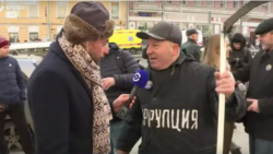 With "Corruption" emblazoned on his chest and a scythe in his hand, one Nemtsov march participant in Moscow called on Russians to mow down the vice. "Corruption is Russia's coronavirus," he quipped to Current Time's Timur Olevsky.