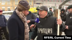 With "Corruption" emblazoned on his chest and a scythe in his hand, one Nemtsov march participant in Moscow called on Russians to mow down the vice. "Corruption is Russia's coronavirus," he quipped to Current Time's Timur Olevsky.