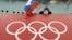 RUSSIA -- A Russian skating fan holds the country's national flag over the Olympic rings before the start of the men's 10,000-meter speedskating race at Adler Arena Skating Center during the 2014 Winter Olympics in Sochi, February 18, 2014