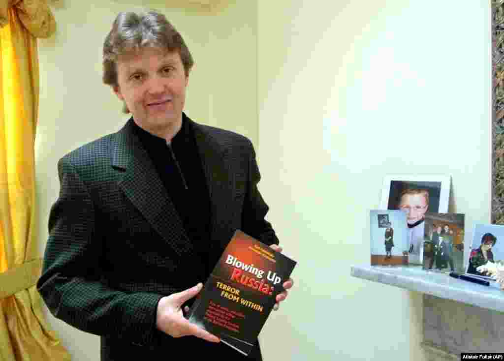 Litvinenko poses with his book, Blowing Up Russia: Terror From Within, at his home in London in May 2002. In the book, he accused the Russian secret services of staging the Russian apartment bombings in 1999 and other acts of terrorism in an effort to bring Vladimir Putin to power.&nbsp;<br />
<br />
Litvinenko fled Russia in 1999 after revealing an alleged plan by the FSB to kill tycoon Boris Berezovsky.&nbsp;<br />
<br />
<br />
&nbsp;