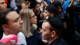 RUSSIA -- Russian opposition candidate and lawyer at the Foundation for Fighting Corruption Lyubov Sobol, center, and other stand in front of police line during a protest in Moscow, July 14, 2019