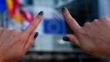 BELGIUM -- A woman shows her finger nails colored in the European colours in front of the European Parliament building in Brussels, May 24, 2019