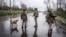 UKRAINE – Servicemen of the 24th Separate Mechanized Brigade of the Ukrainian Armed Forces walk along a street under an anti-drone net in the frontline town of Druzhkivka. Donetsk region, Ukraine April 24, 2026