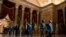 U.S. -- Clerk of the House of Representatives Cheryl L. Johnson, followed by House Speaker Nancy Pelosi's impeachment managers, carry the article of impeachment through Statuary Hall as they pass from the House to the Senate in the US Capitol in Washingto