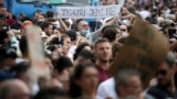 A man wearing a protective face mask holds a sign reading "We are the theatre" as he attends a protest against the demolition of the National Theatre, during the outbreak of the coronavirus disease (COVID-19), in Tirana