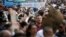 A man wearing a protective face mask holds a sign reading "We are the theatre" as he attends a protest against the demolition of the National Theatre, during the outbreak of the coronavirus disease (COVID-19), in Tirana