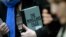 U.K. -- A supporter of WikiLeaks founder julian Assange holds a copy of The WikiLeaks Files outside the Ecuadorian embassy in central London, February 5, 2016