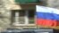 Poland -- Russian drivers, participants of the 'Roads of Glory' automobile rally, drive in their car with a Russian flag after laying flowers at the Soviet Military Cemetery in Warsaw, April 22, 2015
