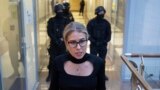 RUSSIA -- Russian opposition activist and lawyer at the Anti-Corruption Foundation (FBK), Lyubov Sobol, reacts as she walks in front of police officers inside the FBK headquarters in Moscow, December 26, 2019