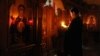 Ukraine -- A priest prays during a memorial service for victims of the violence between the Ukrainian national army and armed pro-Russian separatist militants, at the Svyato-Preobrazhensky cathedral in Donetsk, June 2, 2014