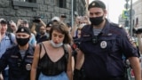 RUSSIA -- MOSCOW, RUSSIA - JULY 7, 2020: Police officers detain a woman who was staging a one-person protest in support of Ivan Safronov, adviser to the Roscosmos State Corporation General Director, detained on suspicion of treason. Safronov is suspected 